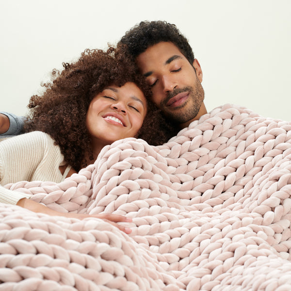 couple on rose quartz velvet weighted blanket